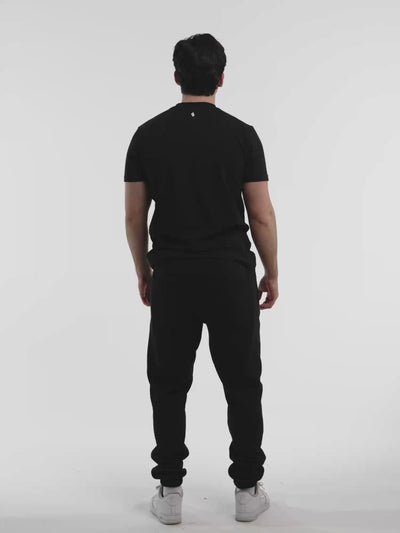 Male model in black ONE BOUT Script T-Shirt — fit and movement