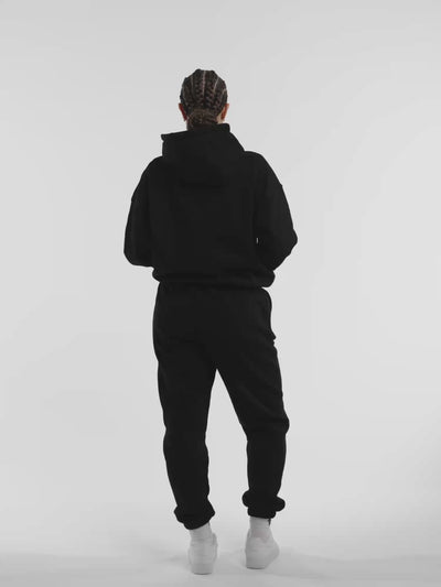 Female model in black ONE BOUT Script Oversized Hoodie — fit and movement