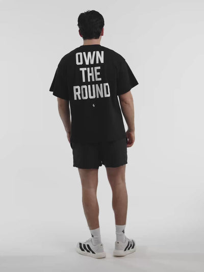 Male model in black ONE BOUT Own The Round oversized t-shirt — fit and movement