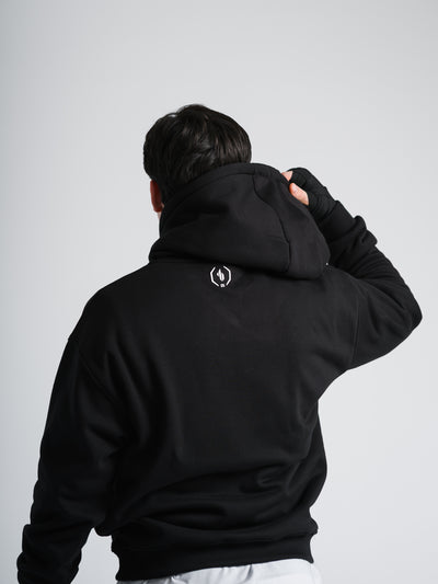 Male model wearing black One Bout Script Oversized Hoodie Limited edition