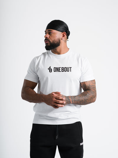 Male model wearing white One Bout Line T-Shirt with enlarged chest logo